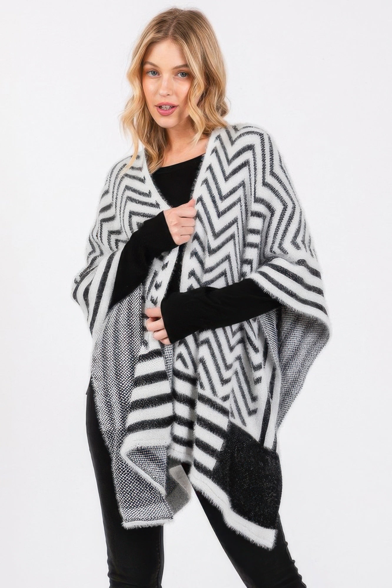 Fuzzy chevron ruana in ivory with black zigzag pattern and soft fringe hem