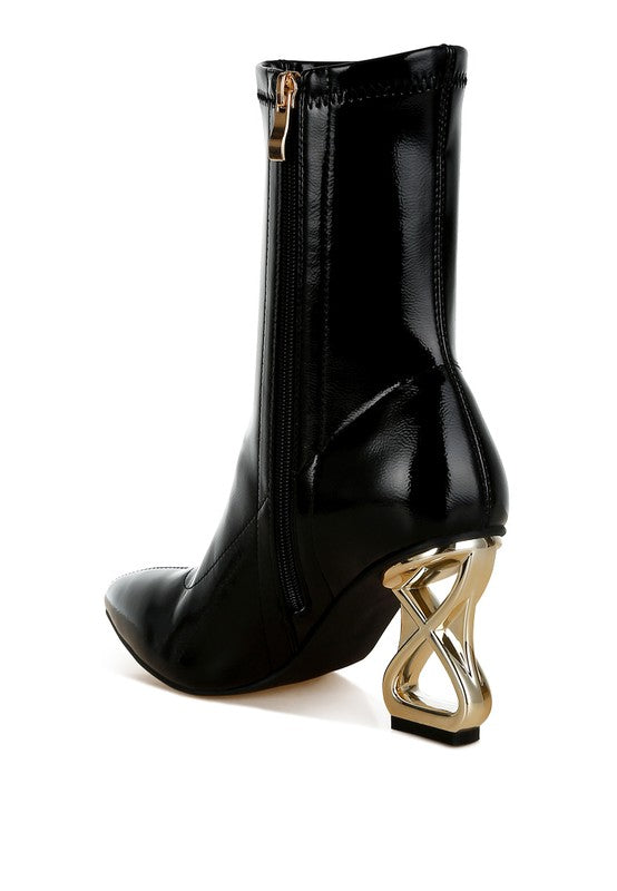 Black patent faux-leather boot with side zipper and gold geometric heel, angled front view