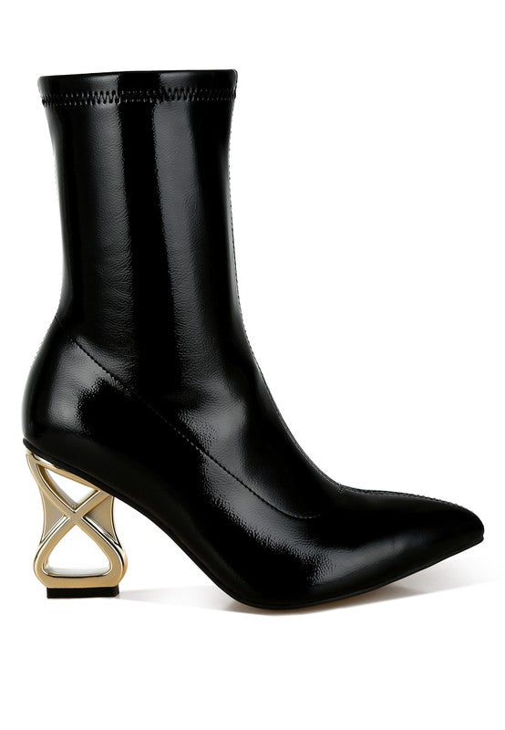 Black patent faux-leather heeled boot with pointed toe and gold geometric block heel