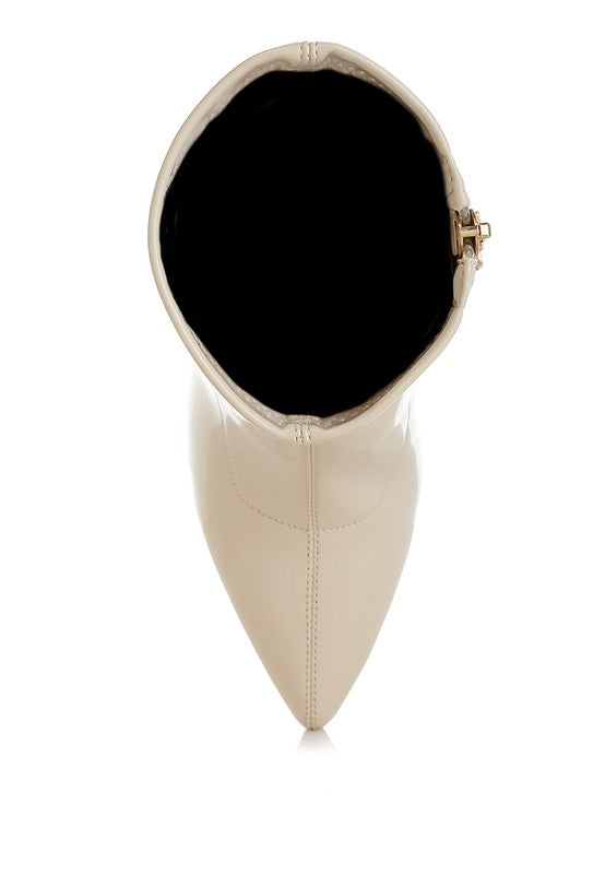 Beige patent faux-leather boot opening and side zipper hardware, pointed toe