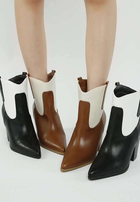 Two-tone cowboy boots with black and white uppers, brown heel and toe stitching accents