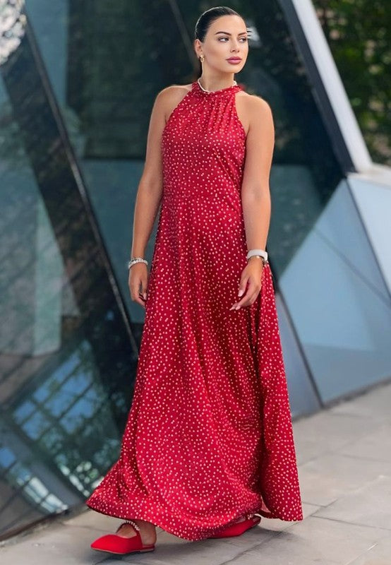 Red embellished mules worn with a long dress, jeweled strap and flat sole