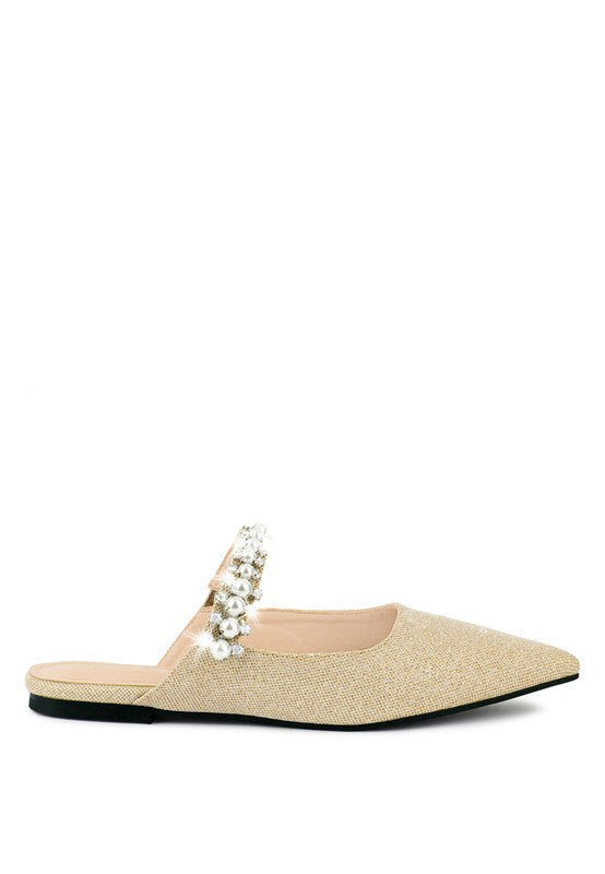Beige cutout mule with pearl bead strap detail and low black sole