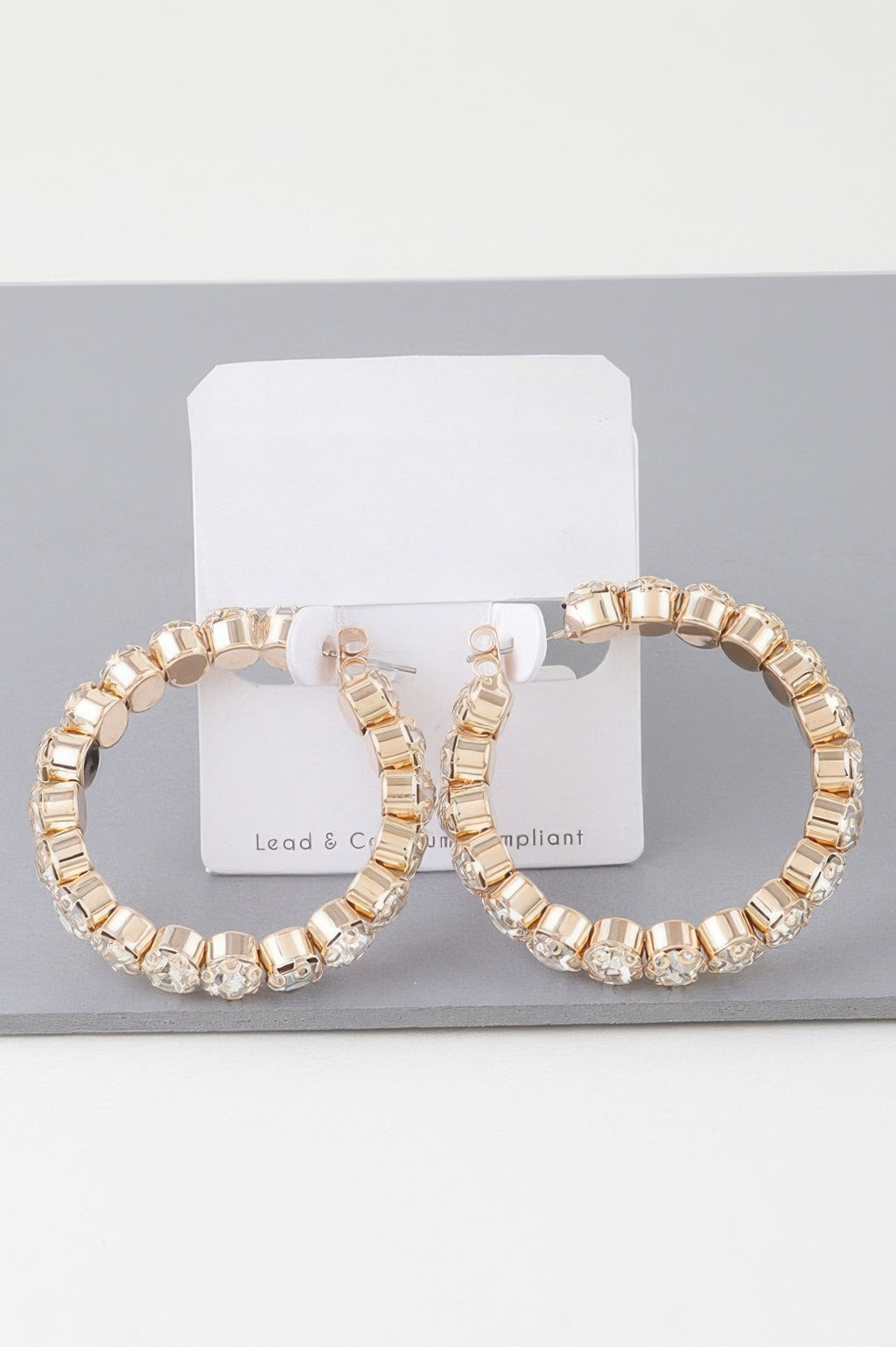 Geometric rhinestone cut hoop earrings, gold-tone with clear stones