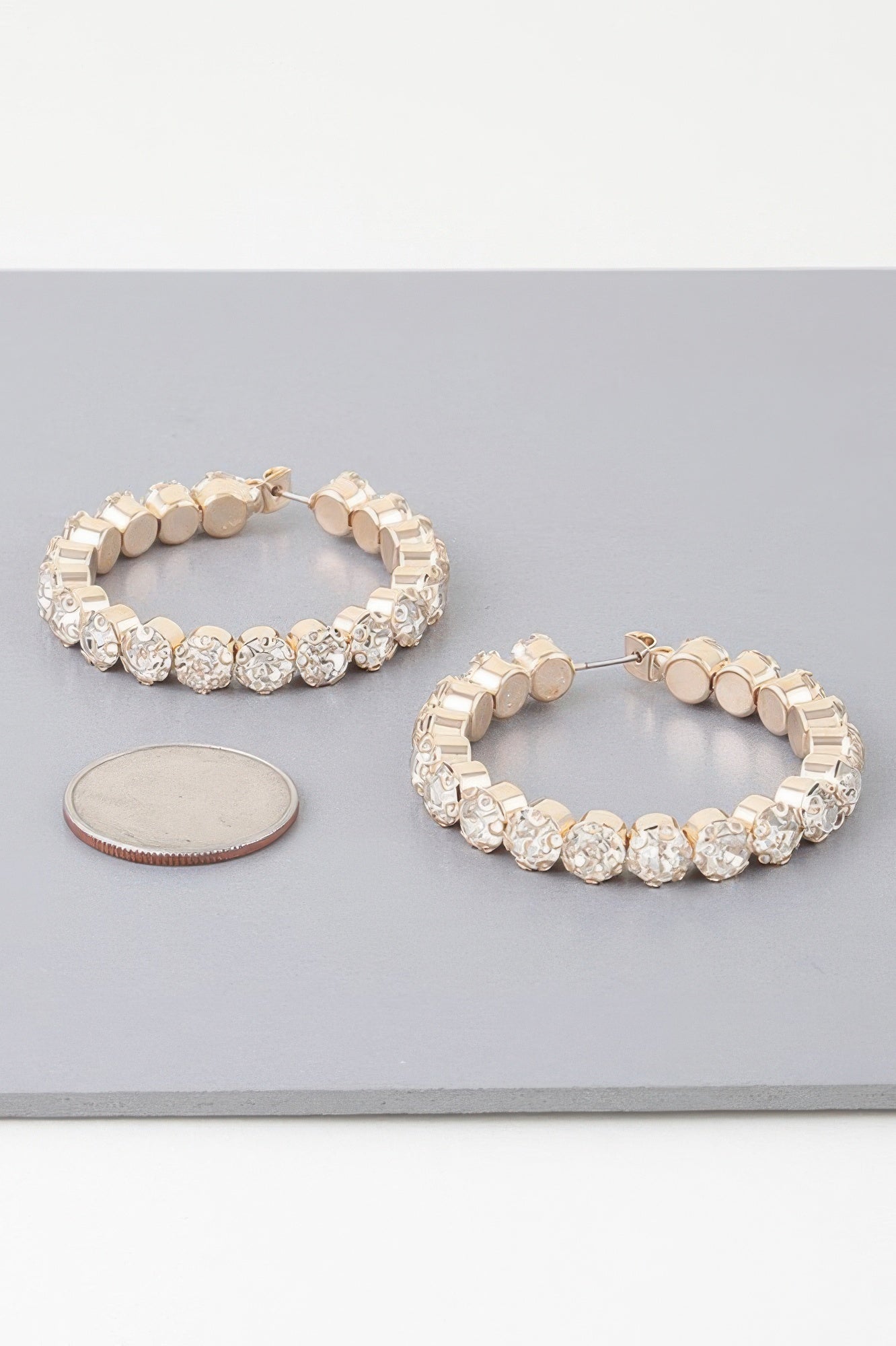 Geometric rhinestone hoop earrings, gold-tone; textured clear stone links