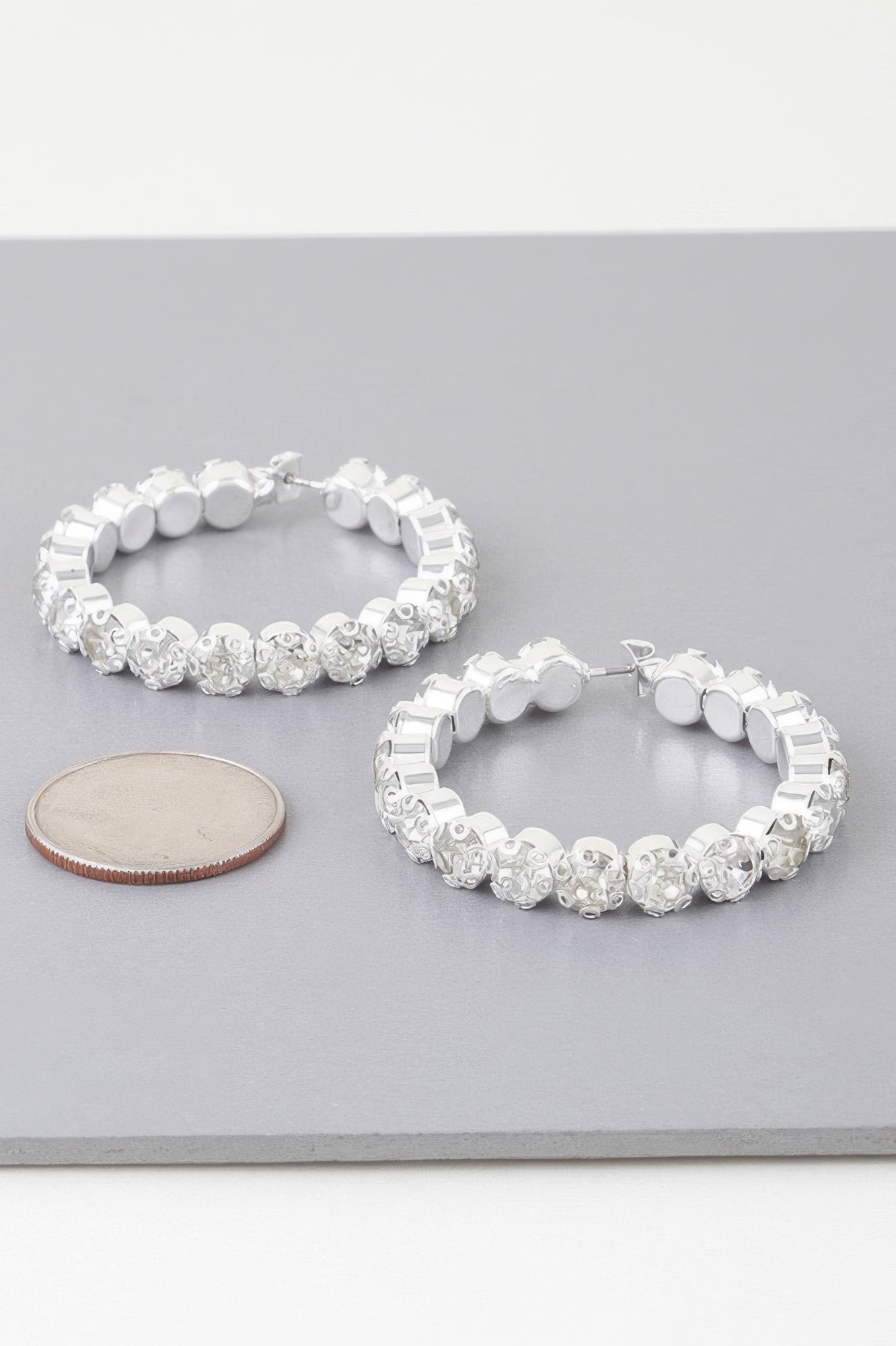 Geometric rhinestone cut hoop earrings, silver-tone with clear stones
