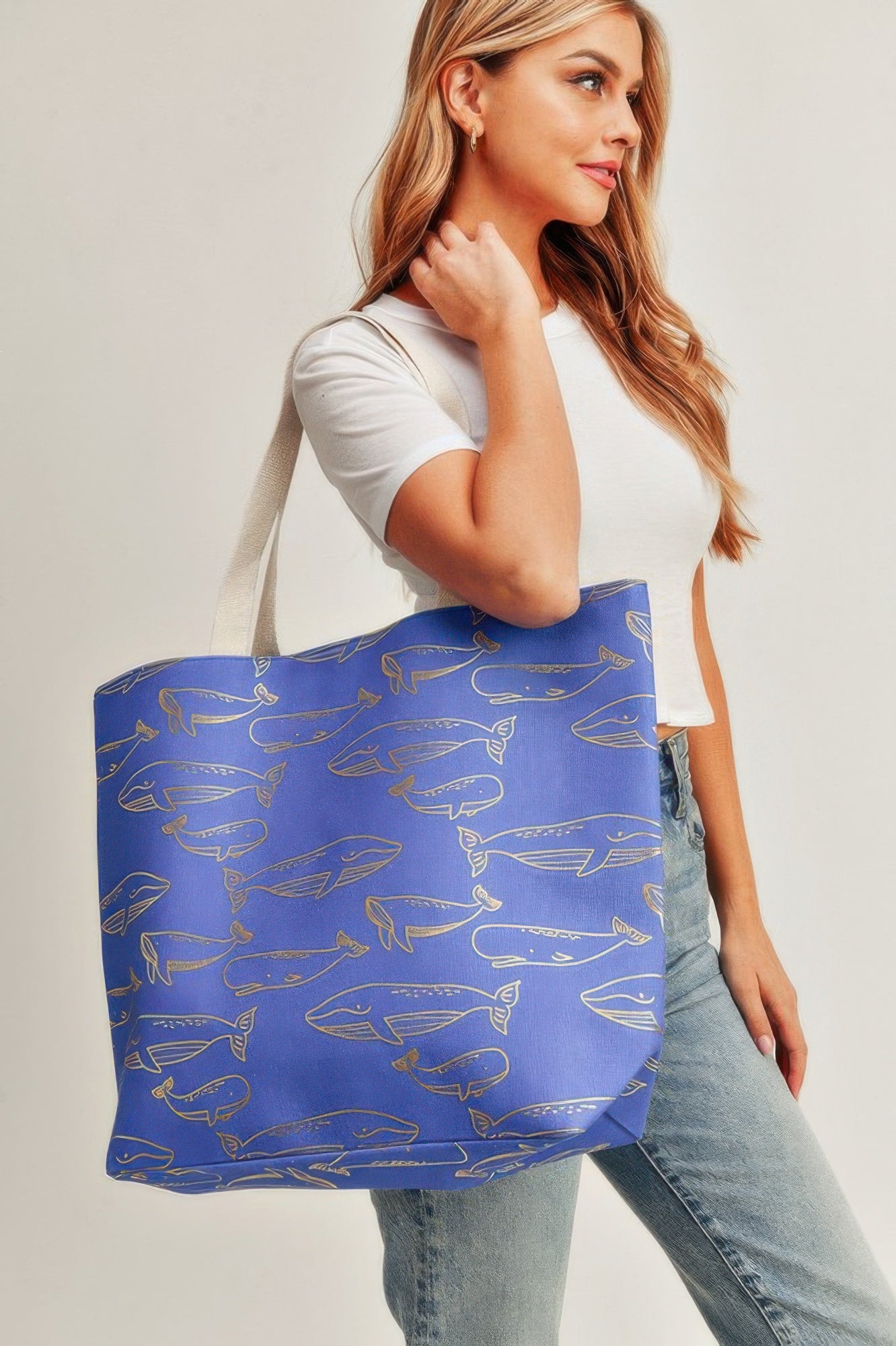 Royal blue tote bag with gold whale foil print and long handles