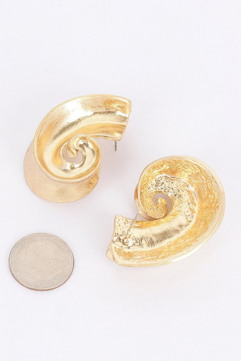 Gold-plated swirl metal earrings with scalloped curved edges, glossy
