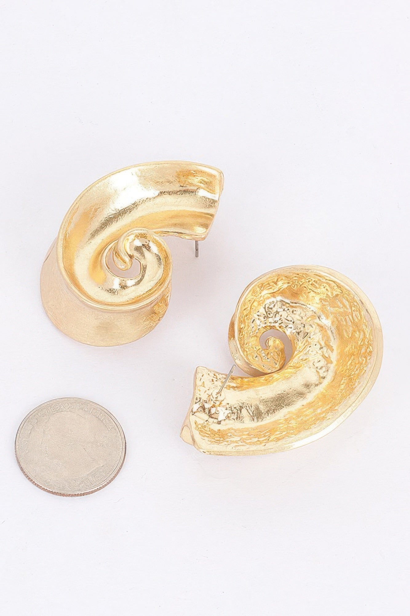 Gold-plated swirl metal earrings with scalloped curved edges, glossy