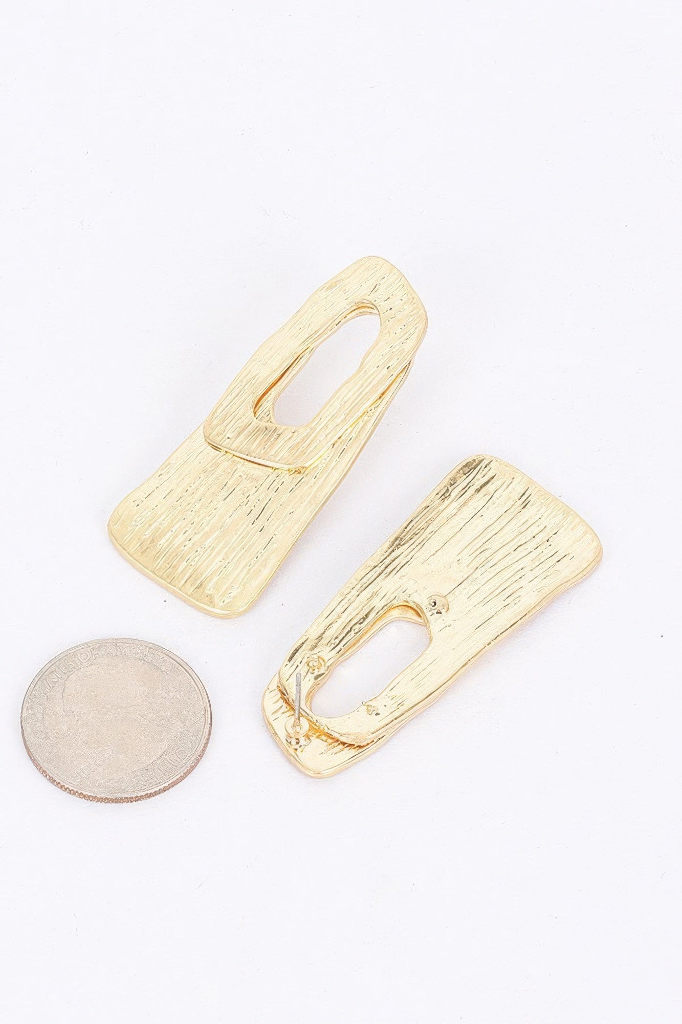Textured gold-tone metal earrings, abstract open-frame shapes with oval holes