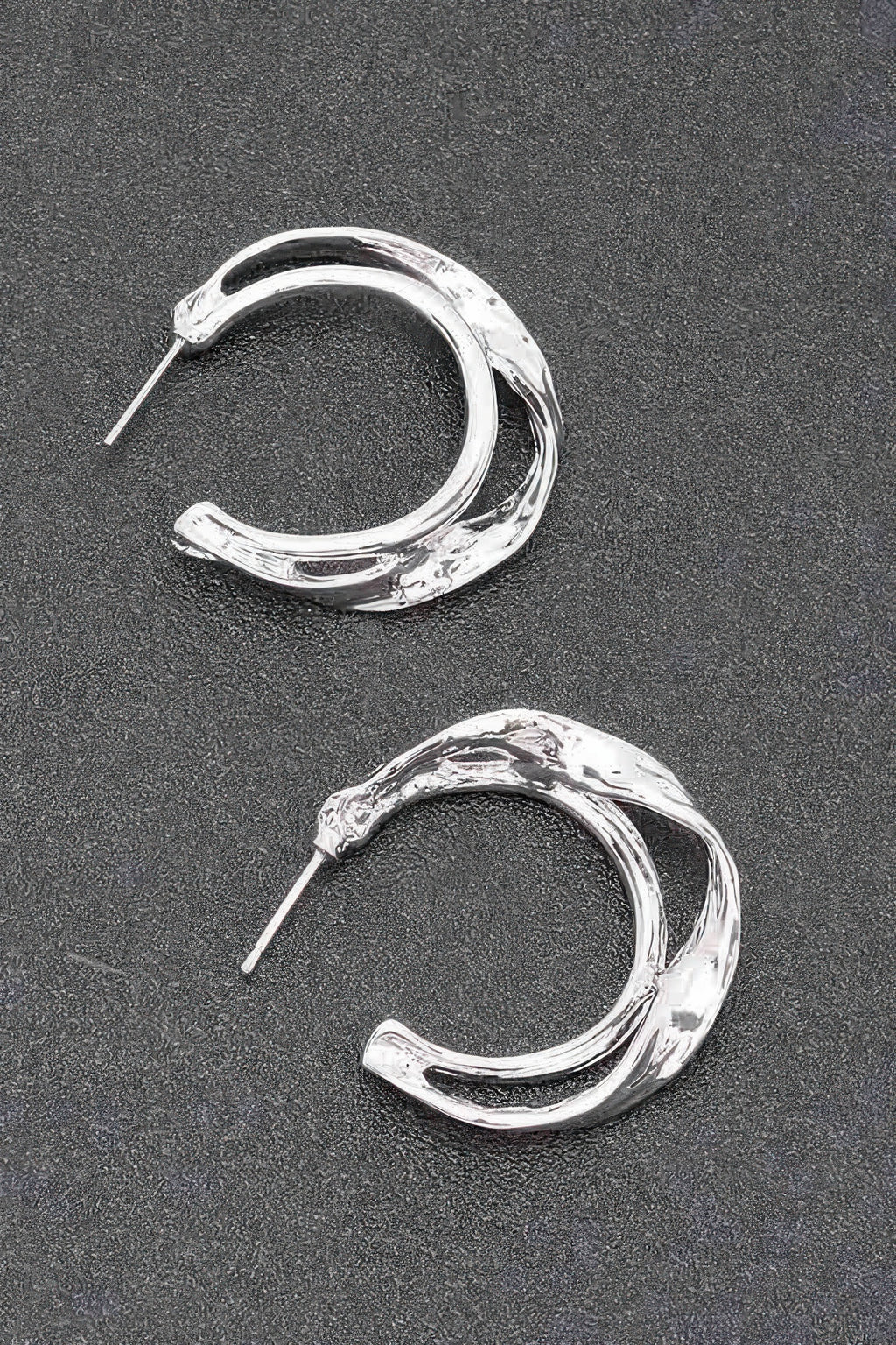 Silver metal hoop earrings with textured finish and straight stud posts
