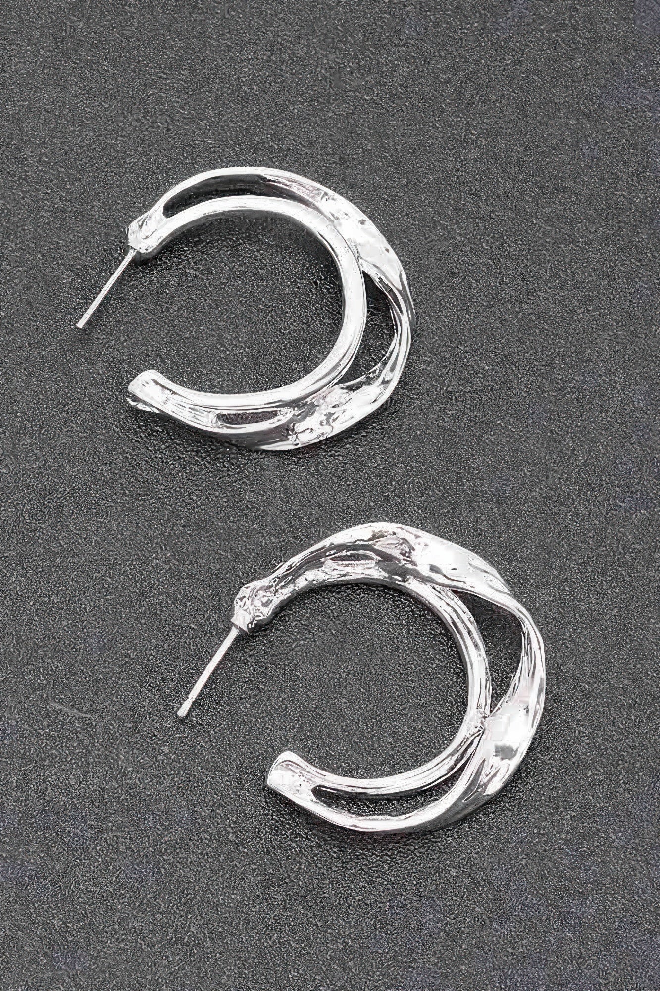 Silver metal hoop earrings with textured finish and straight stud posts