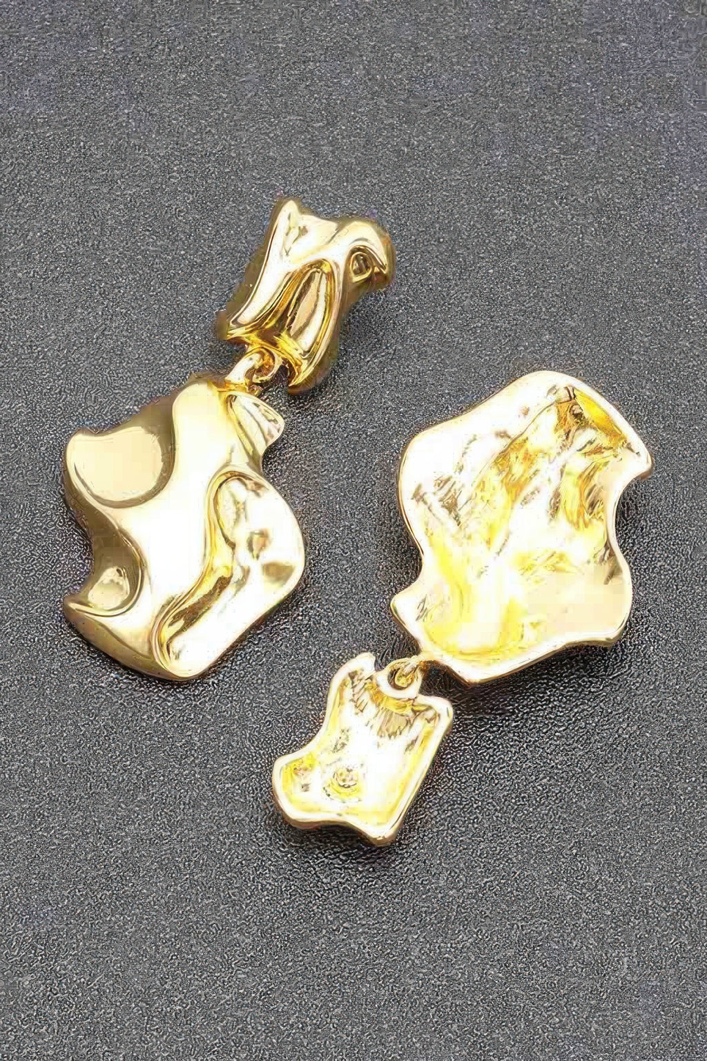 Gold-plated metal earrings, detailed view of chunky abstract drop shapes