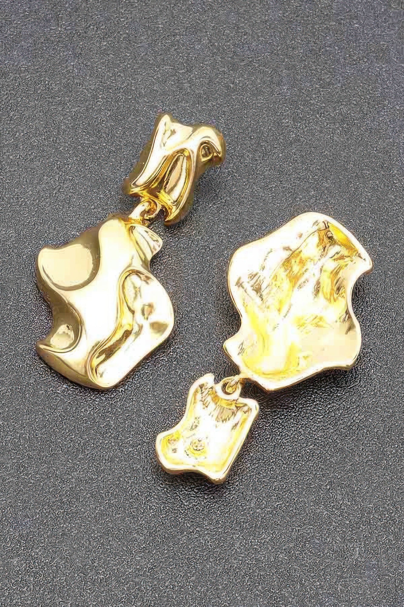 Gold-plated metal earrings, detailed view of chunky abstract drop shapes