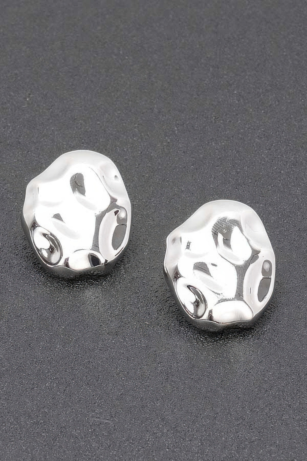 Silvertone metal stud earrings with irregular hammered oval shape
