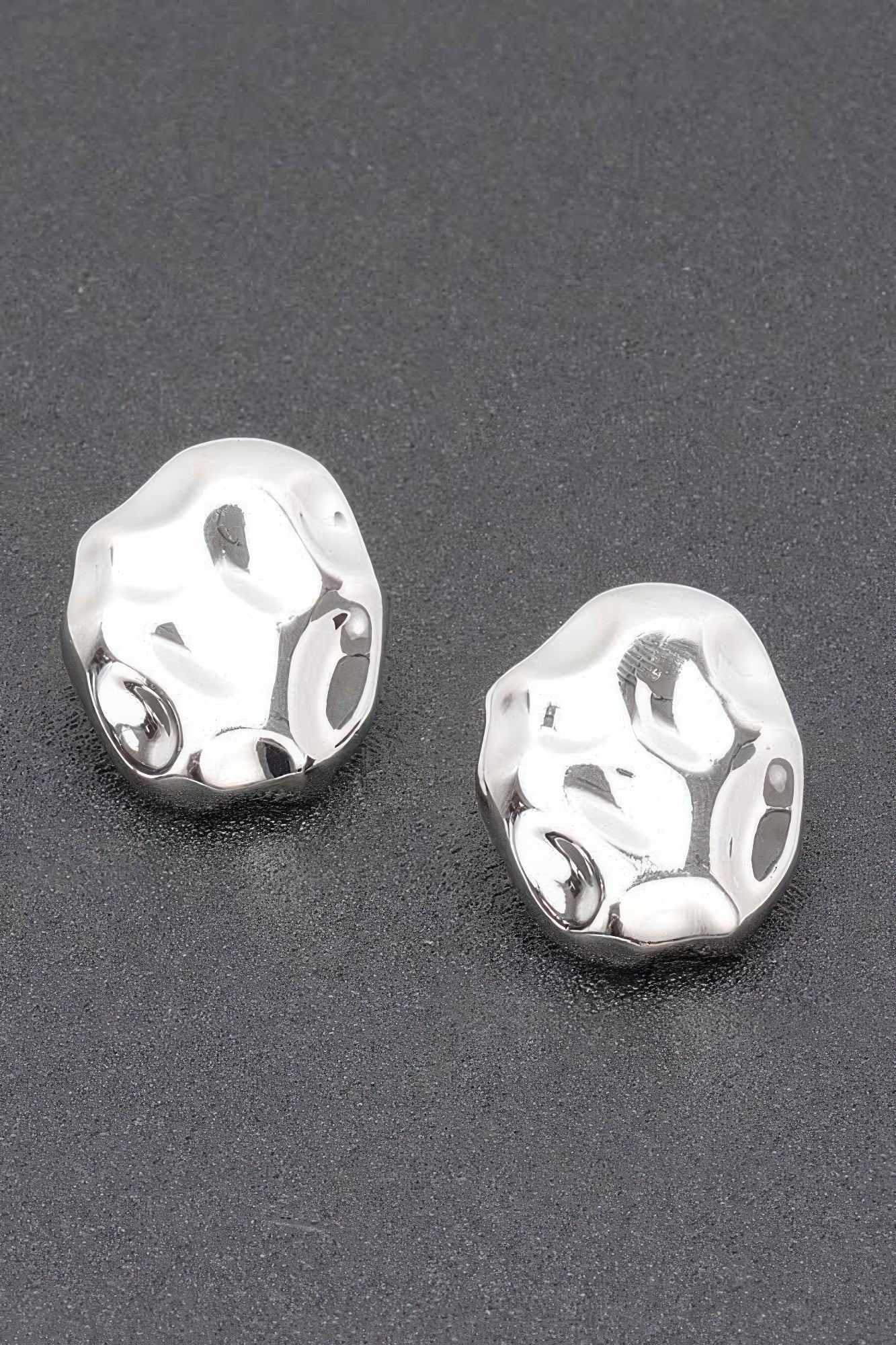Silvertone metal stud earrings with irregular hammered oval shape