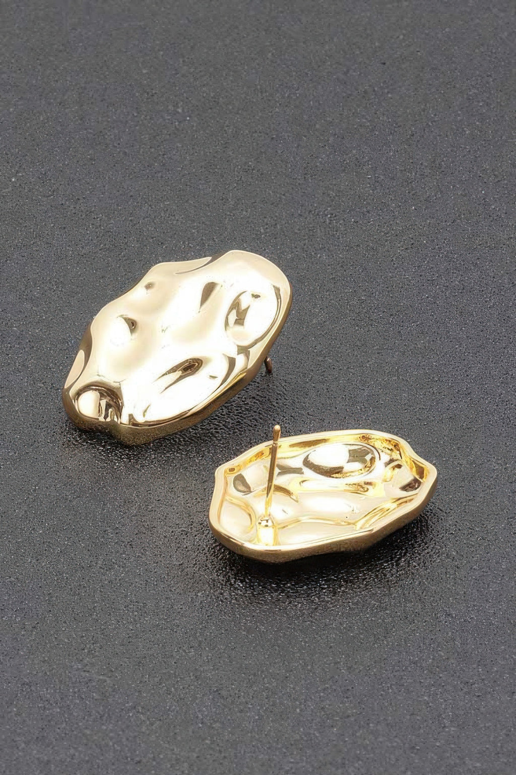Goldtone metal stud earrings, irregular hammered surface, post back visible