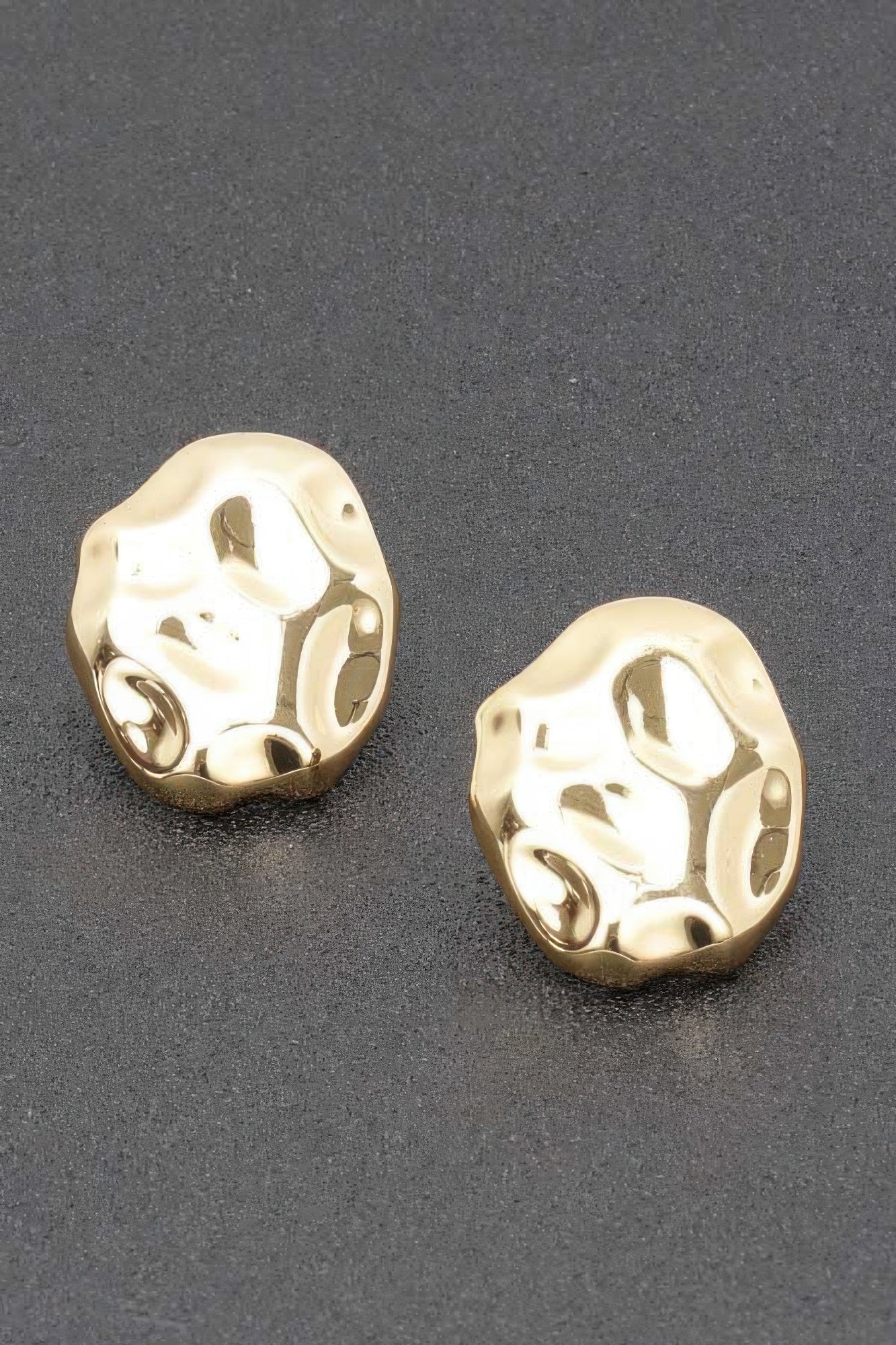 Goldtone metal stud earrings with irregular hammered oval front