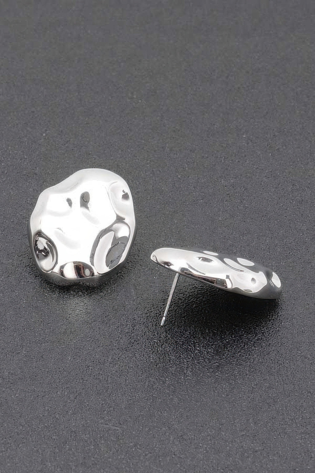 Silvertone metal stud earrings with irregular hammered oval shape and post