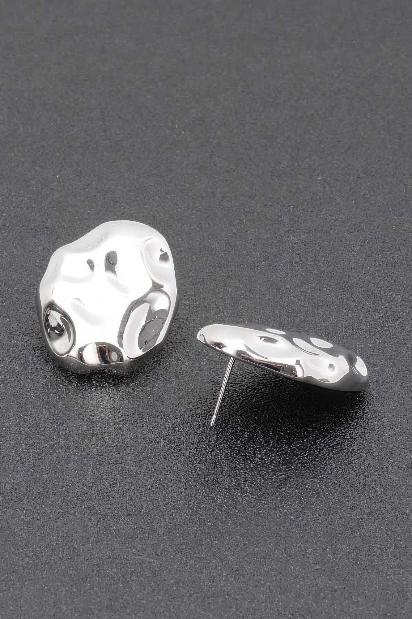Silvertone metal stud earrings with irregular hammered oval shape and post