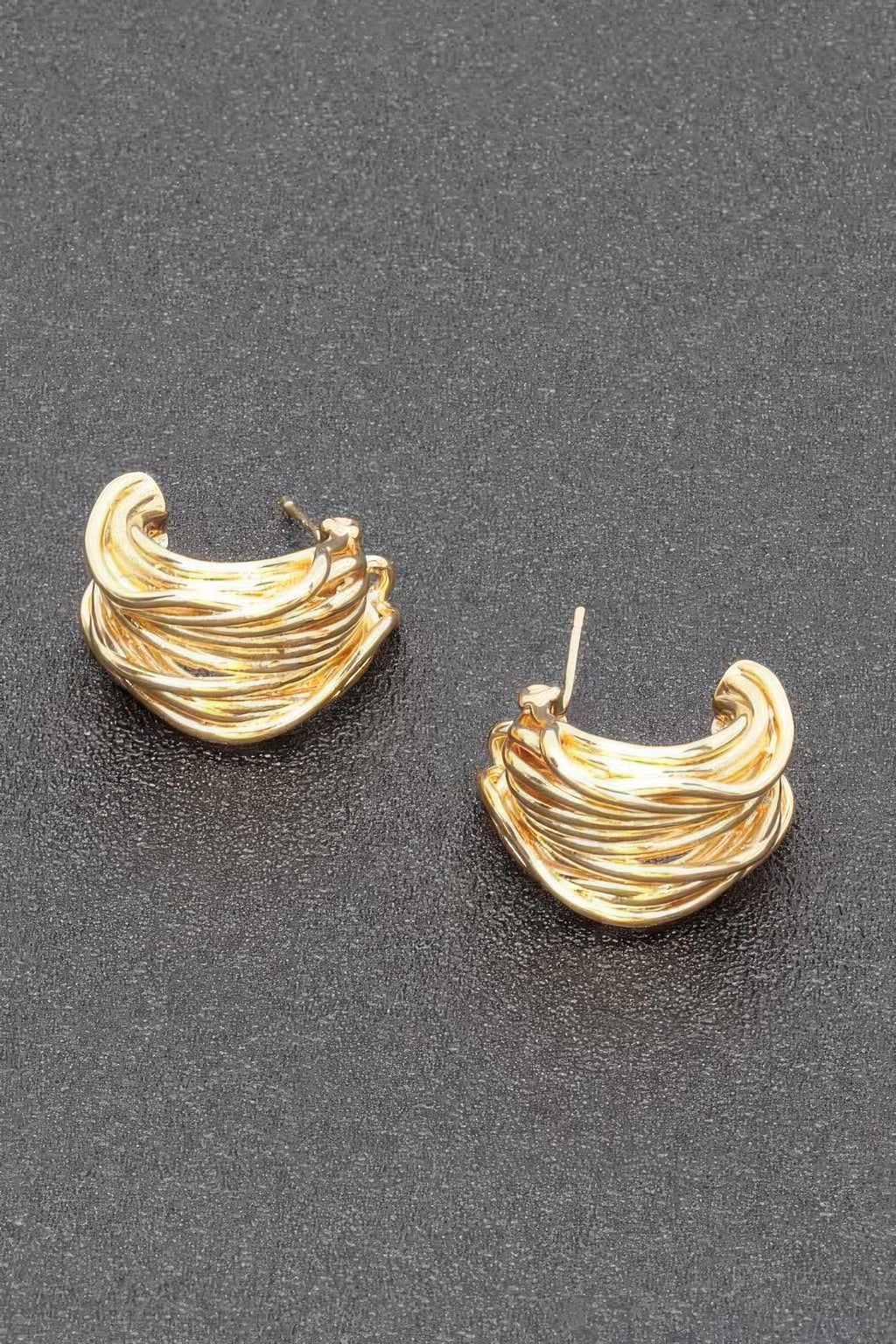 Gold-plated metal hoop earrings with twisted swirl design