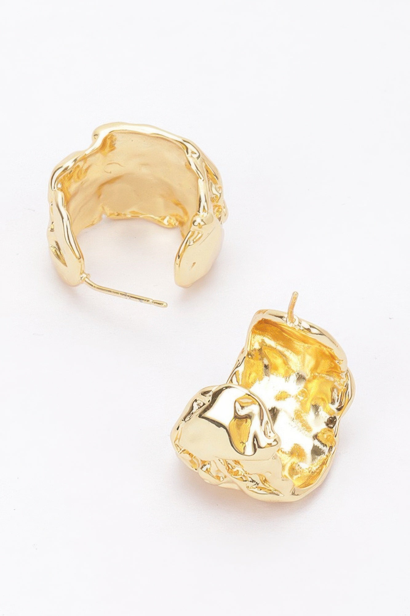 Gold-plated metal crescent earrings, thick hammered texture; post and inner opening