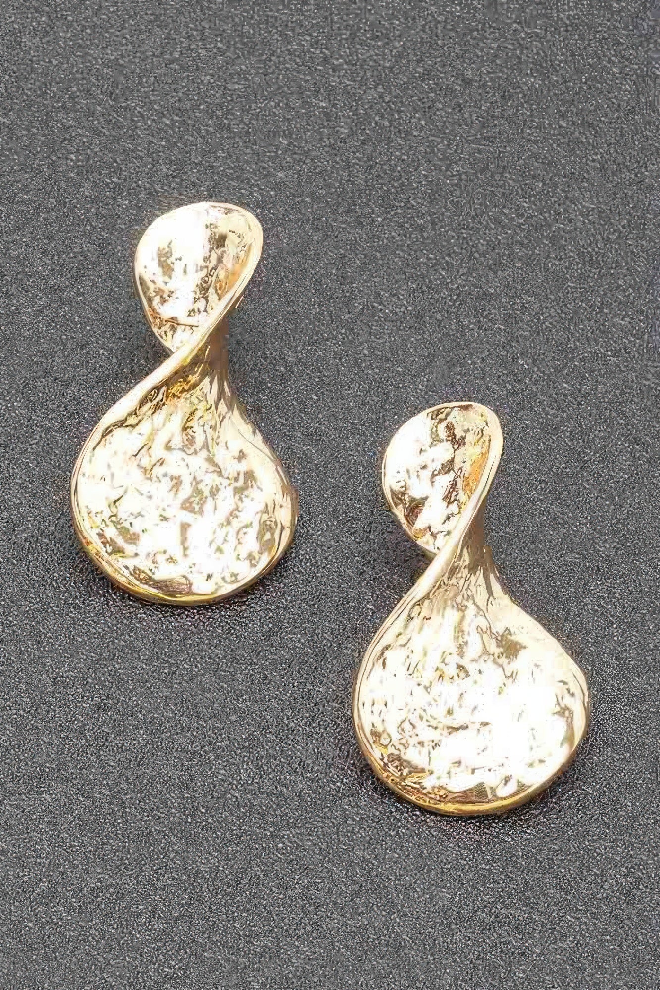 Gold plated teardrop metal earrings with irregular marbled texture and gold rim