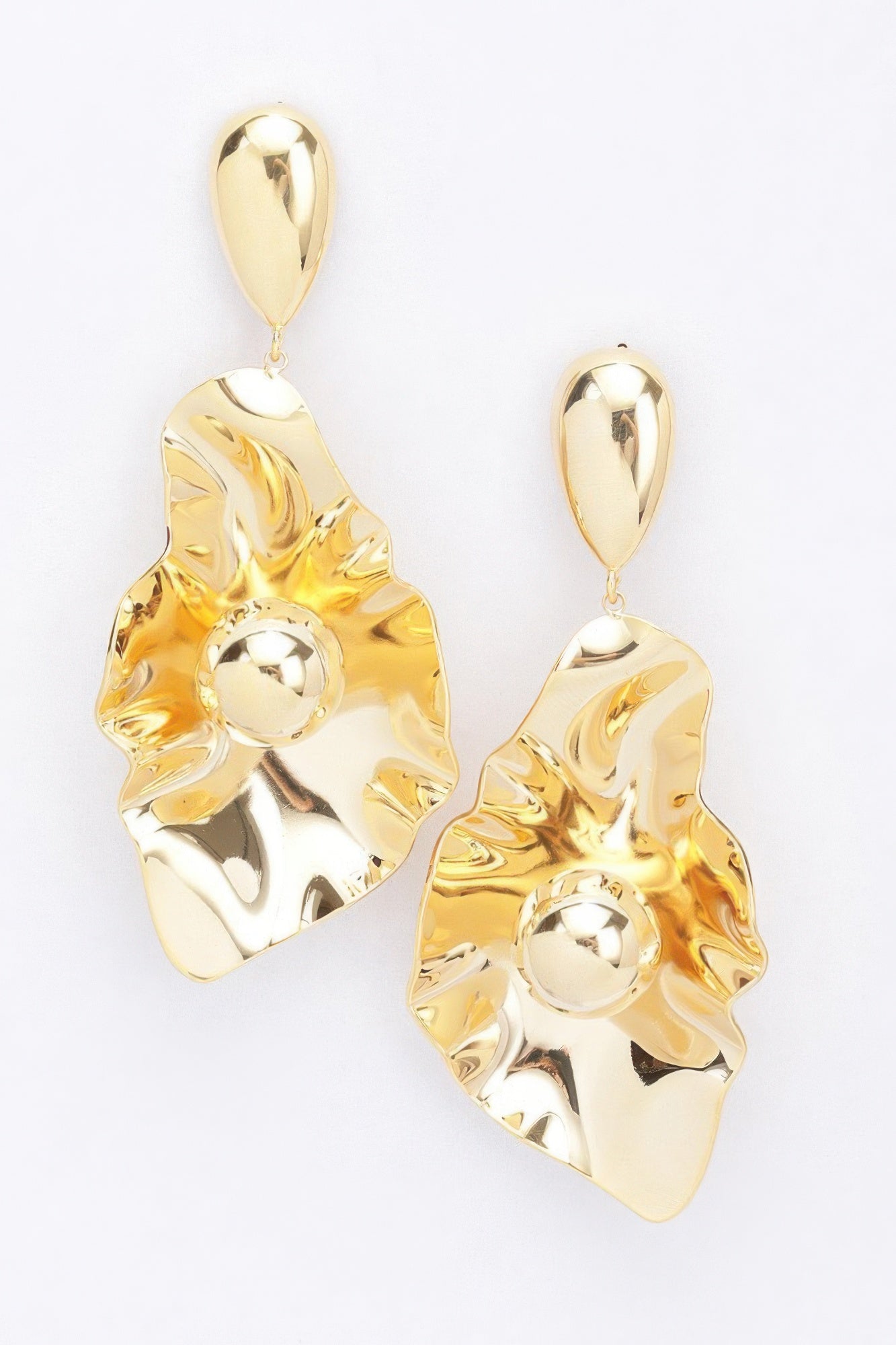 Gold-plated metal earrings with scalloped leaf shape, round center, and teardrop dangle