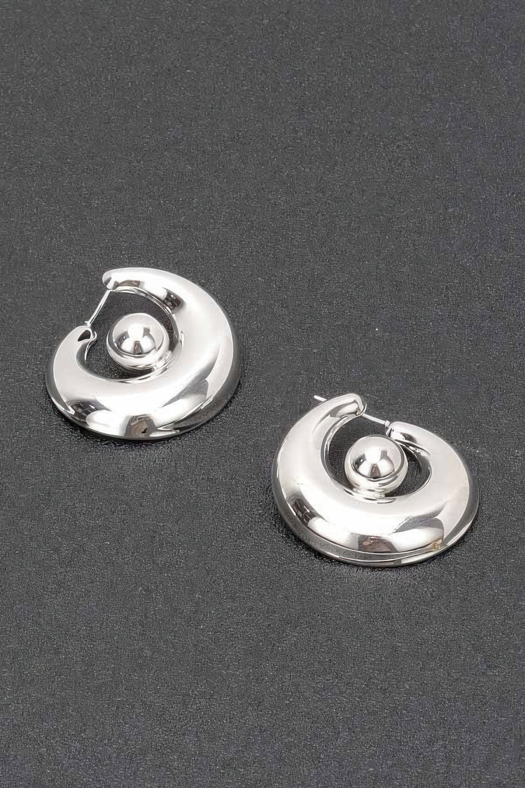 Silver plated metal hoop earrings with central round ball accent