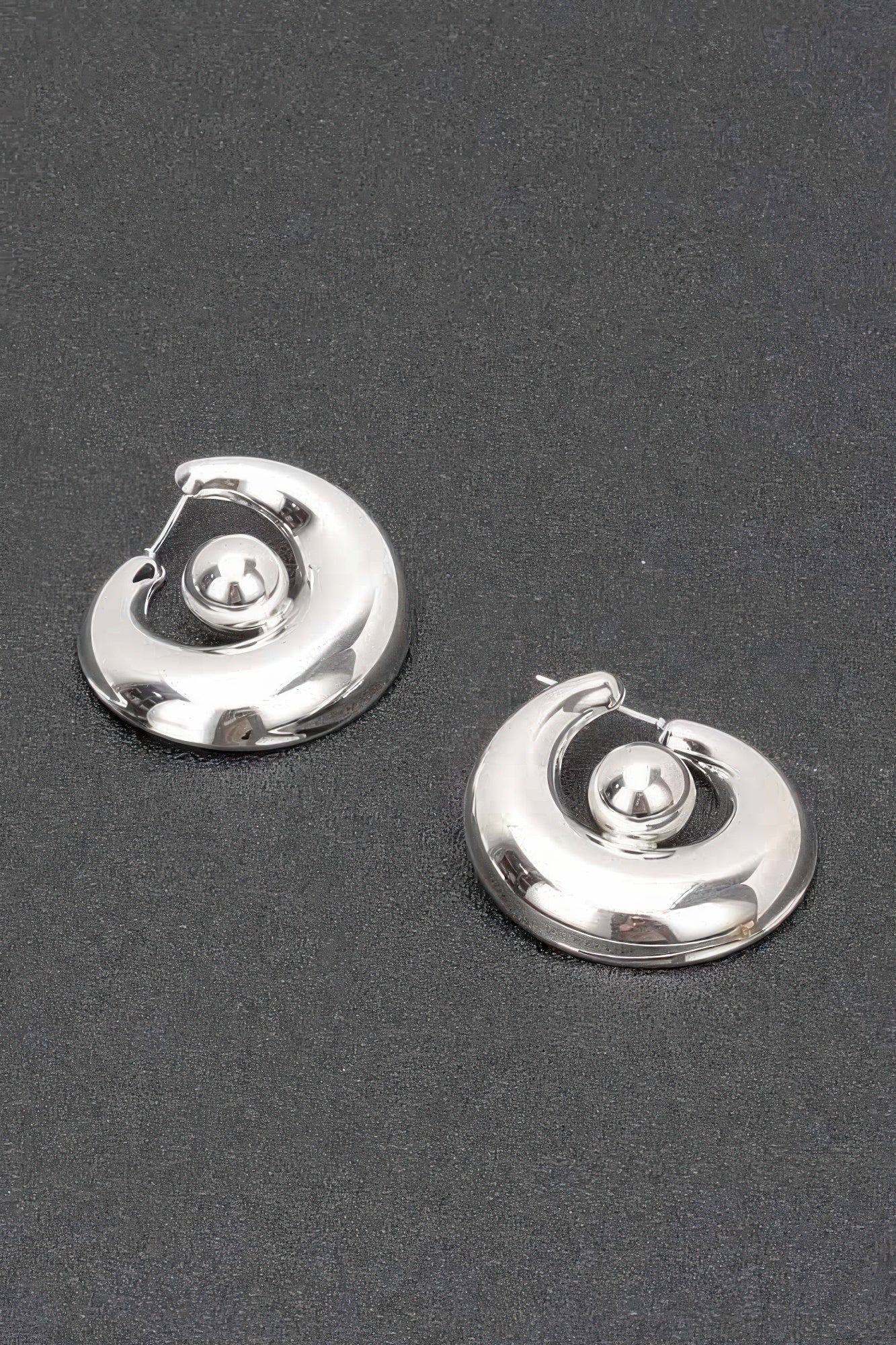 Silver plated metal hoop earrings with central round ball accent