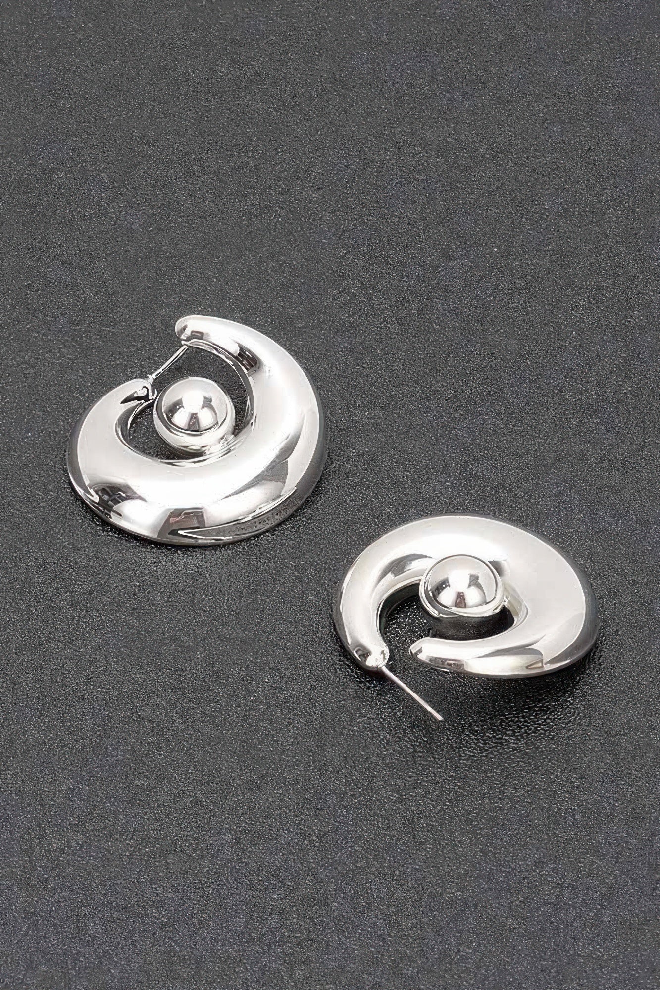 Silver hoop earrings with needle backs and glossy circular hoop design