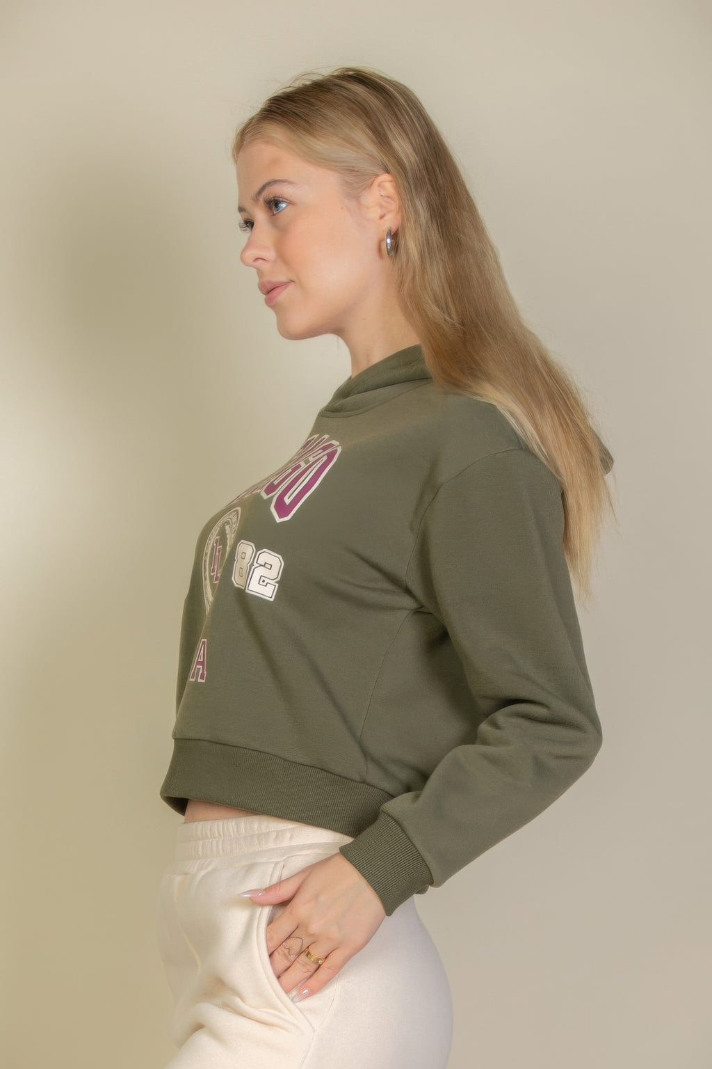 Side view of olive graphic hoodie with partial Chicago emblem print
