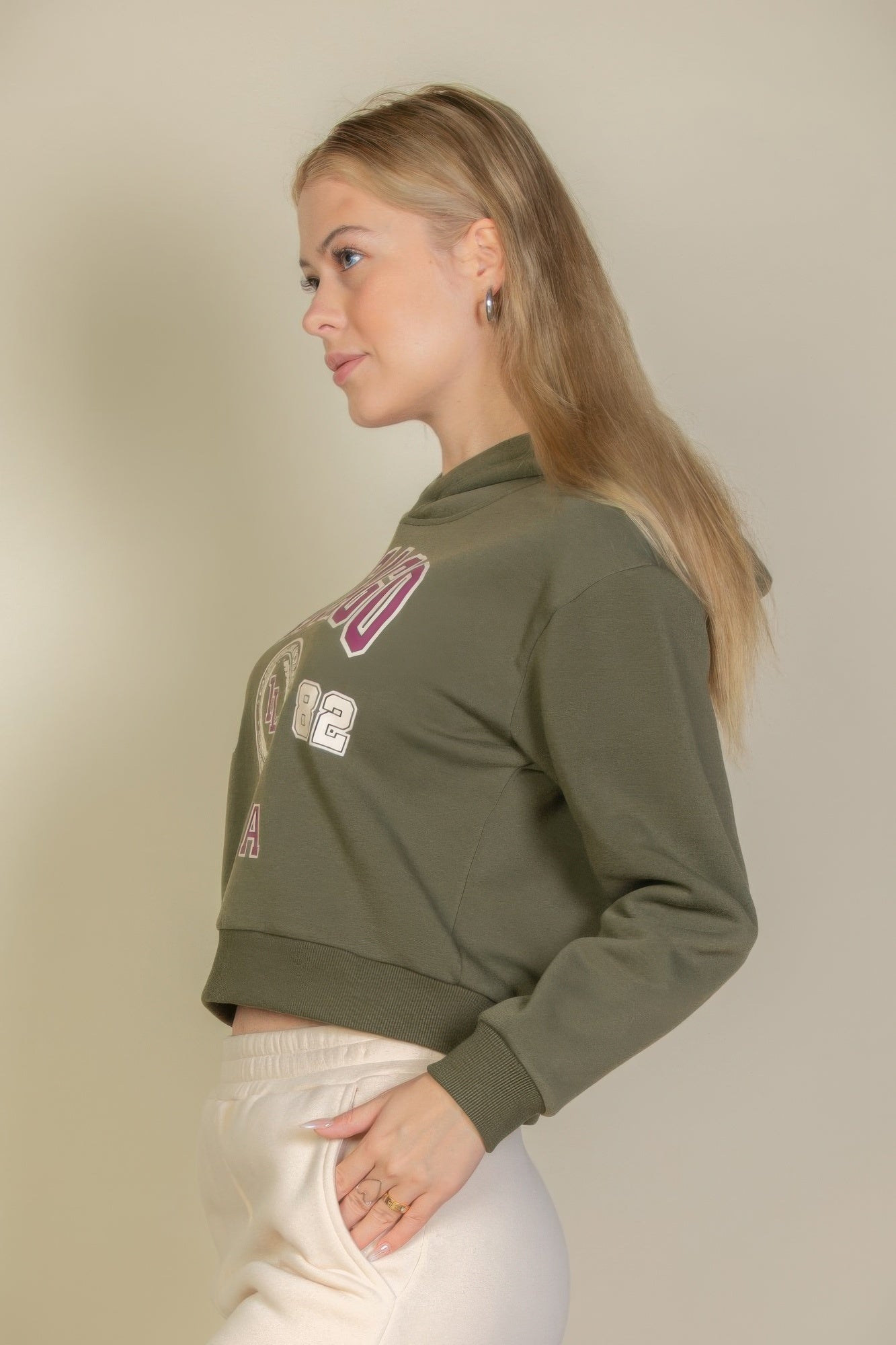 Side view of olive graphic hoodie with partial Chicago emblem print