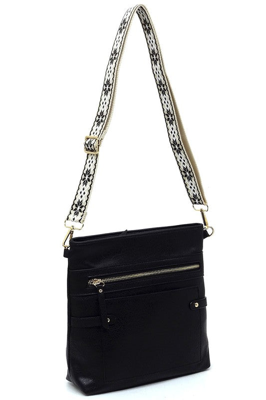 Black crossbody bag with front zip and patterned shoulder strap