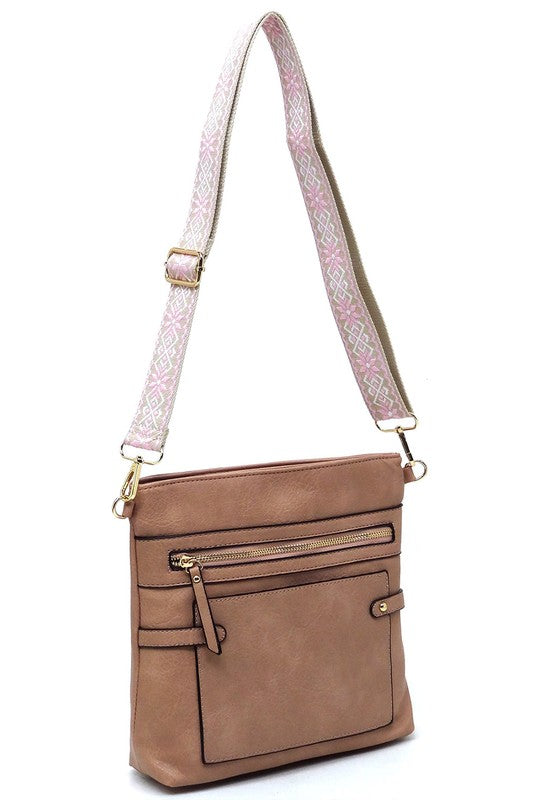 Tan crossbody bag with front zip pocket and patterned shoulder strap