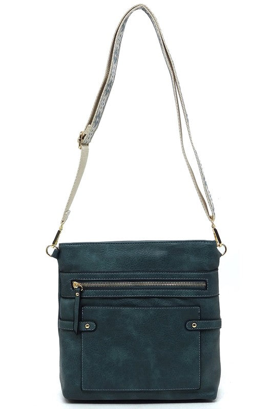 Teal guitar strap crossbody bag with front zip pocket and patterned adjustable strap
