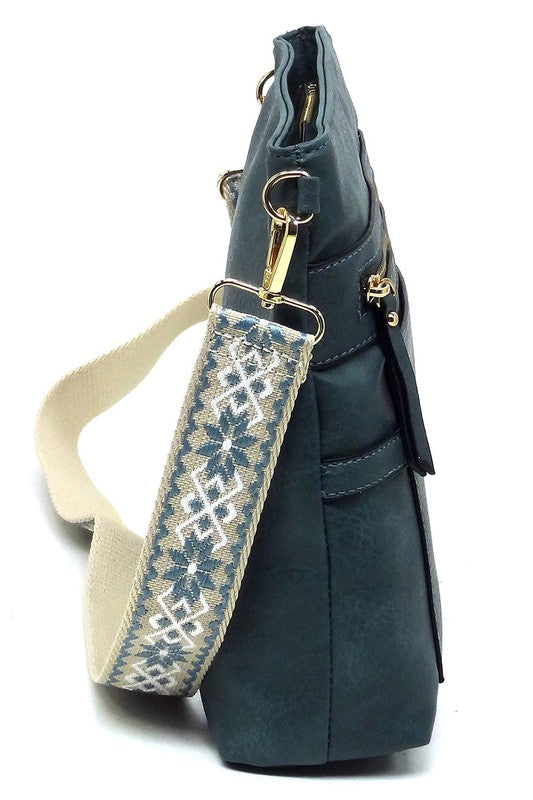 Teal guitar strap crossbody bag side view with top zipper and patterned shoulder strap