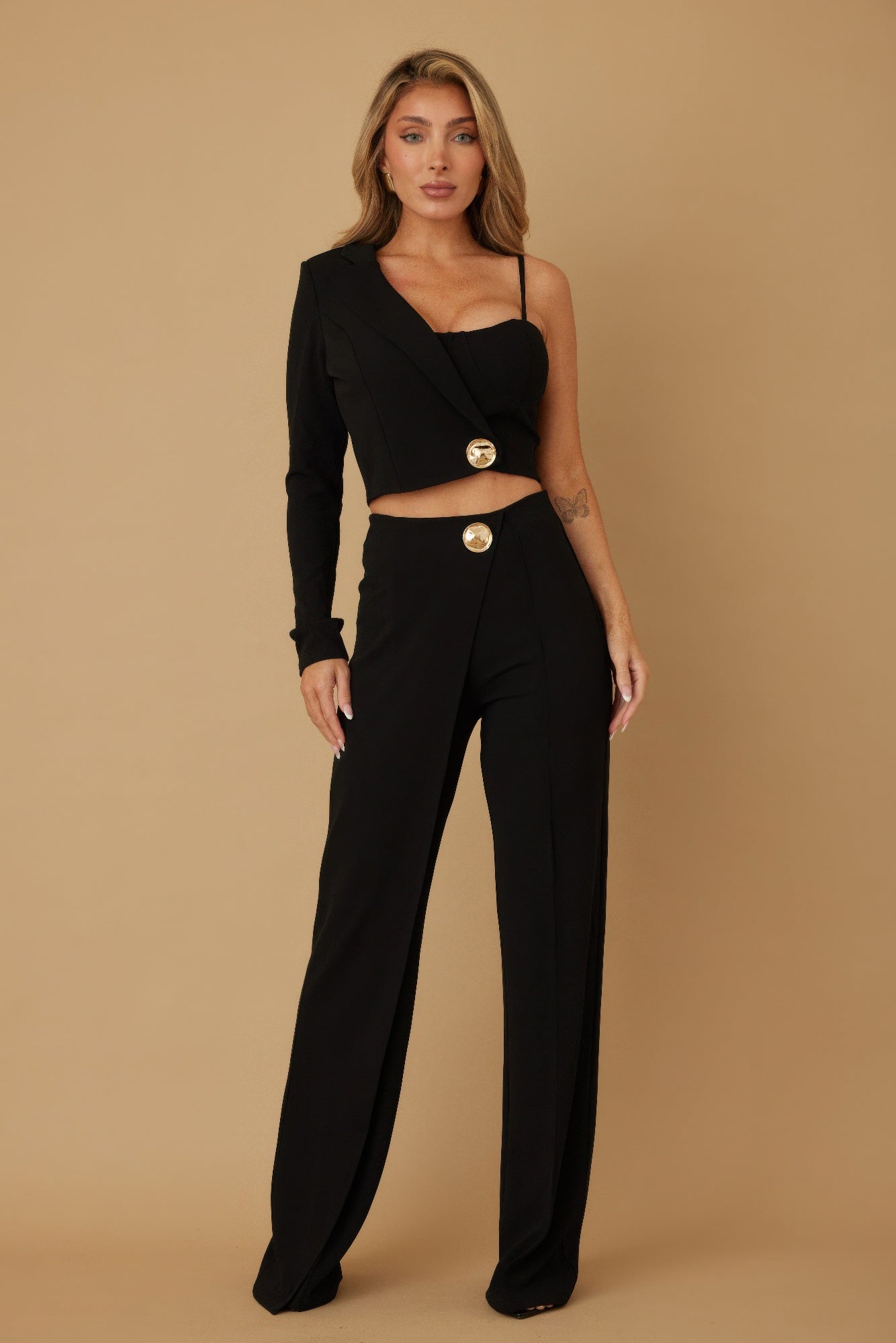 Black two-piece set with one-shoulder camisole, cropped blazer, and wide-leg pants