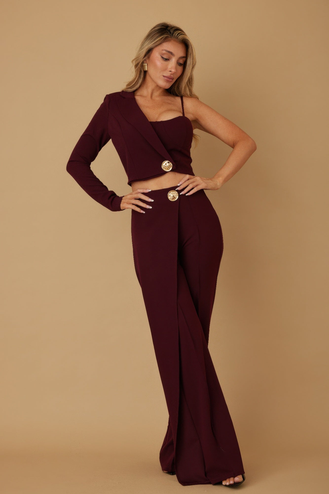 Wine two-piece set: one-shoulder top, cropped blazer, and wide-leg trousers with buttons