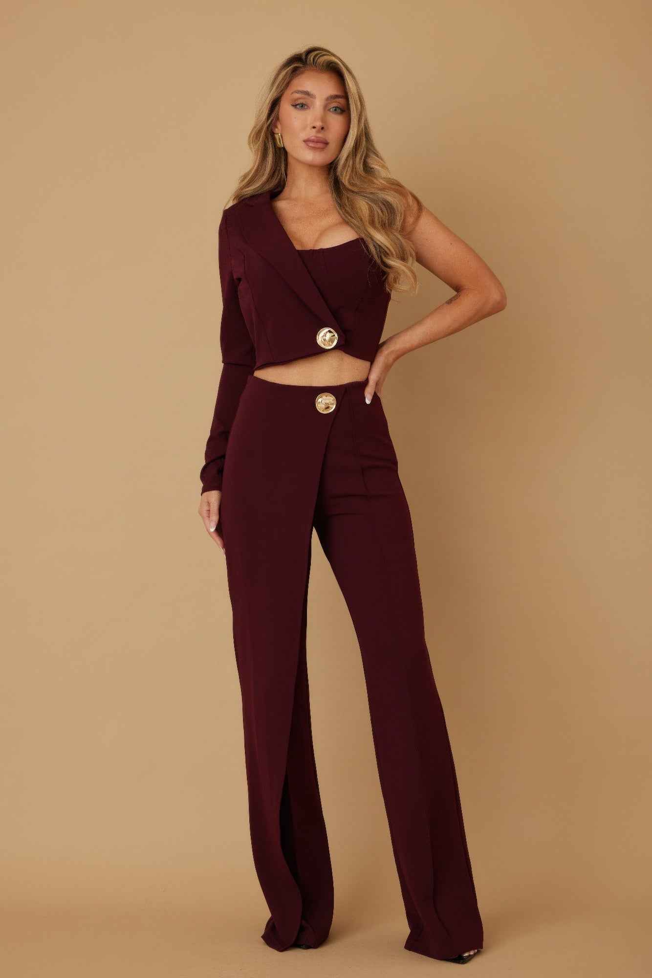 Wine two-piece set featuring one-shoulder bodice, cropped jacket, and flared trousers