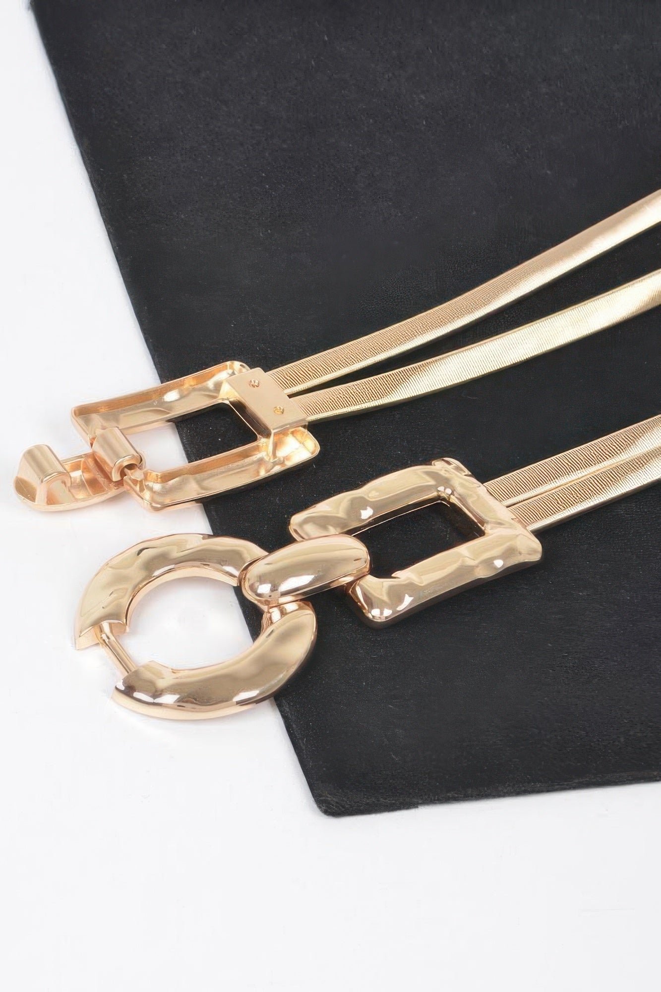 Close-up: gold stretch belt with O-ring buckle and rectangular clasp