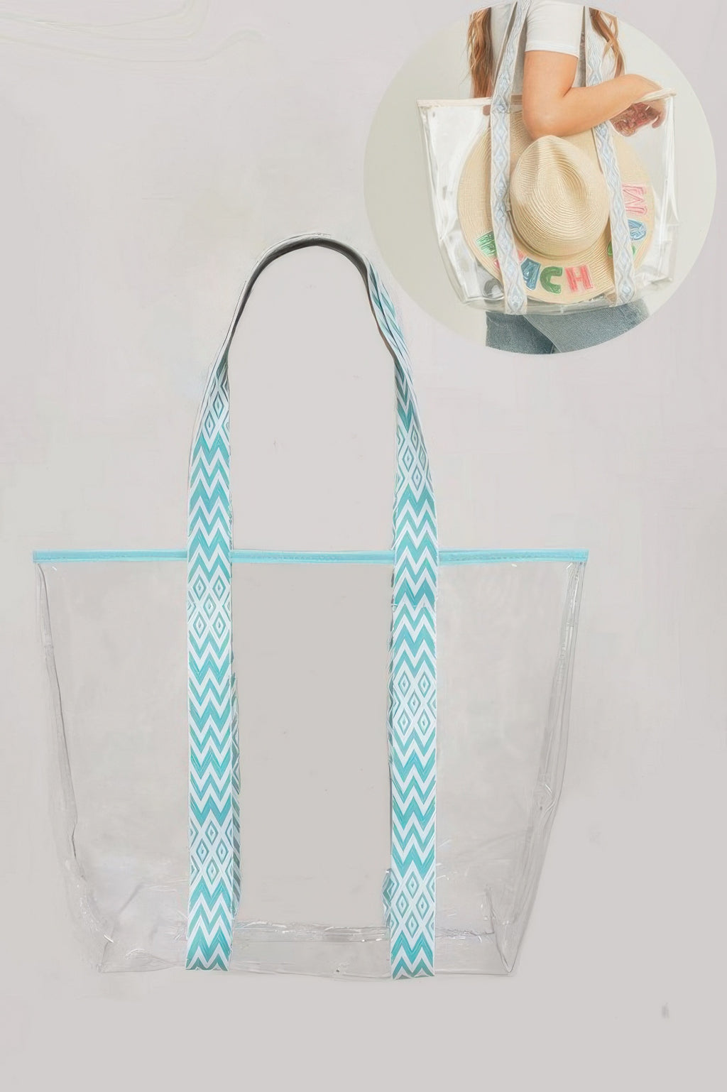 Clear tote bag with mint zipper and teal chevron handles, front view.