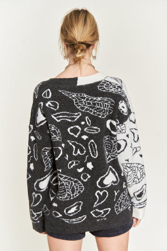 Back view: heart paisley color-block cardigan in charcoal with ivory heart-graphic pattern