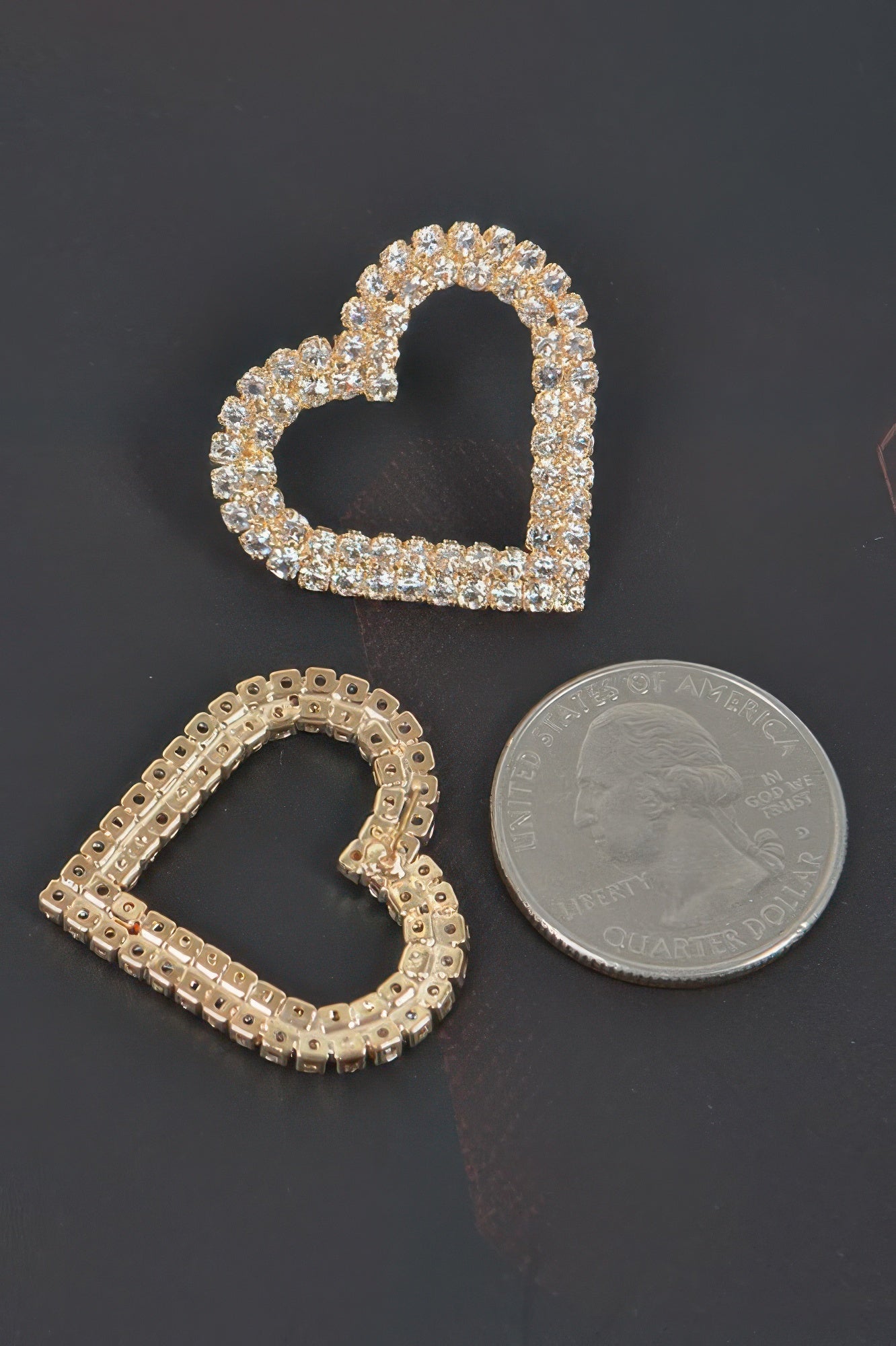 Gold-tone heart rhinestone studs with post backs; coin for size reference