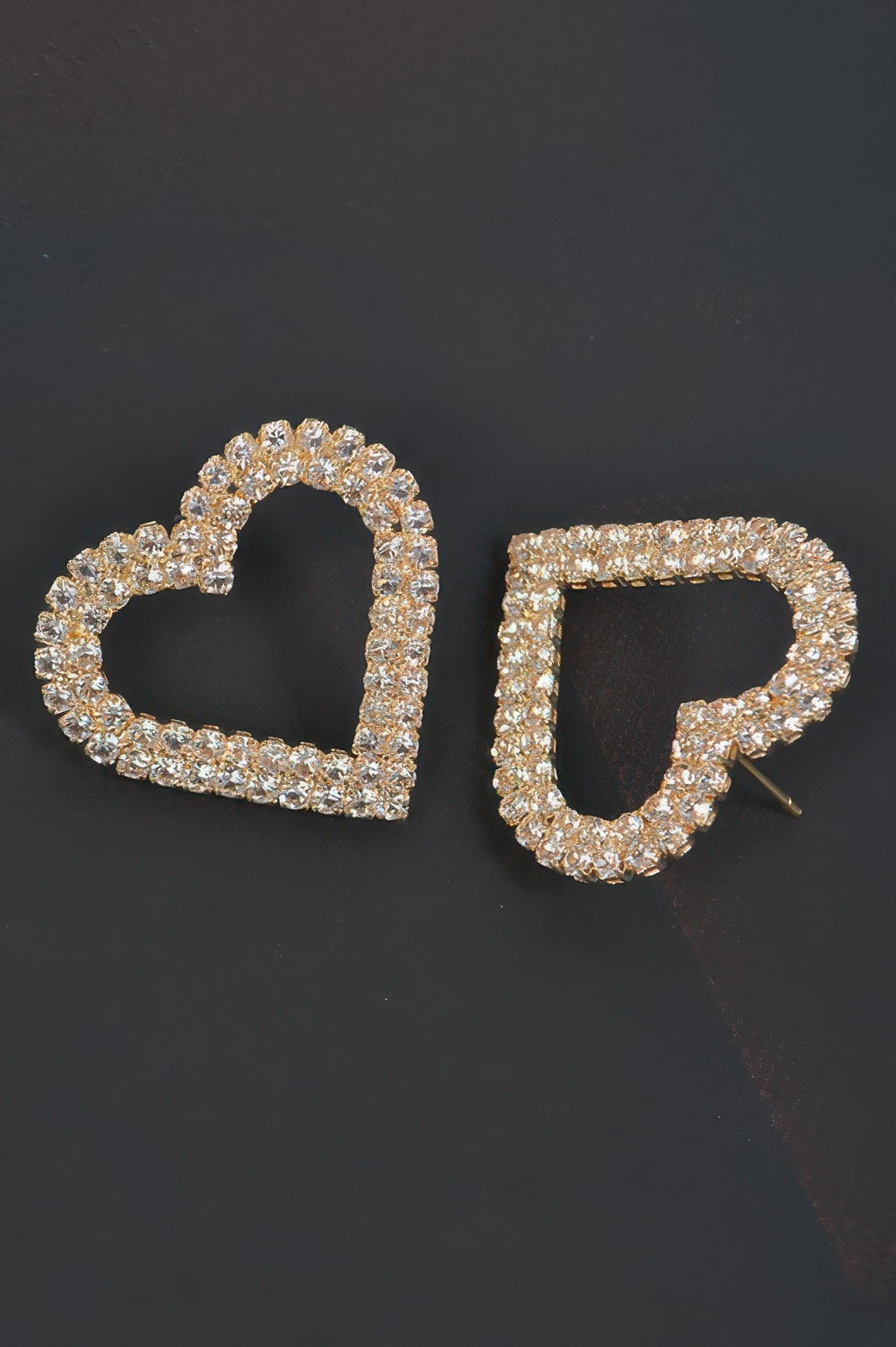Two heart rhinestone earrings in gold-tone setting, one showing the post