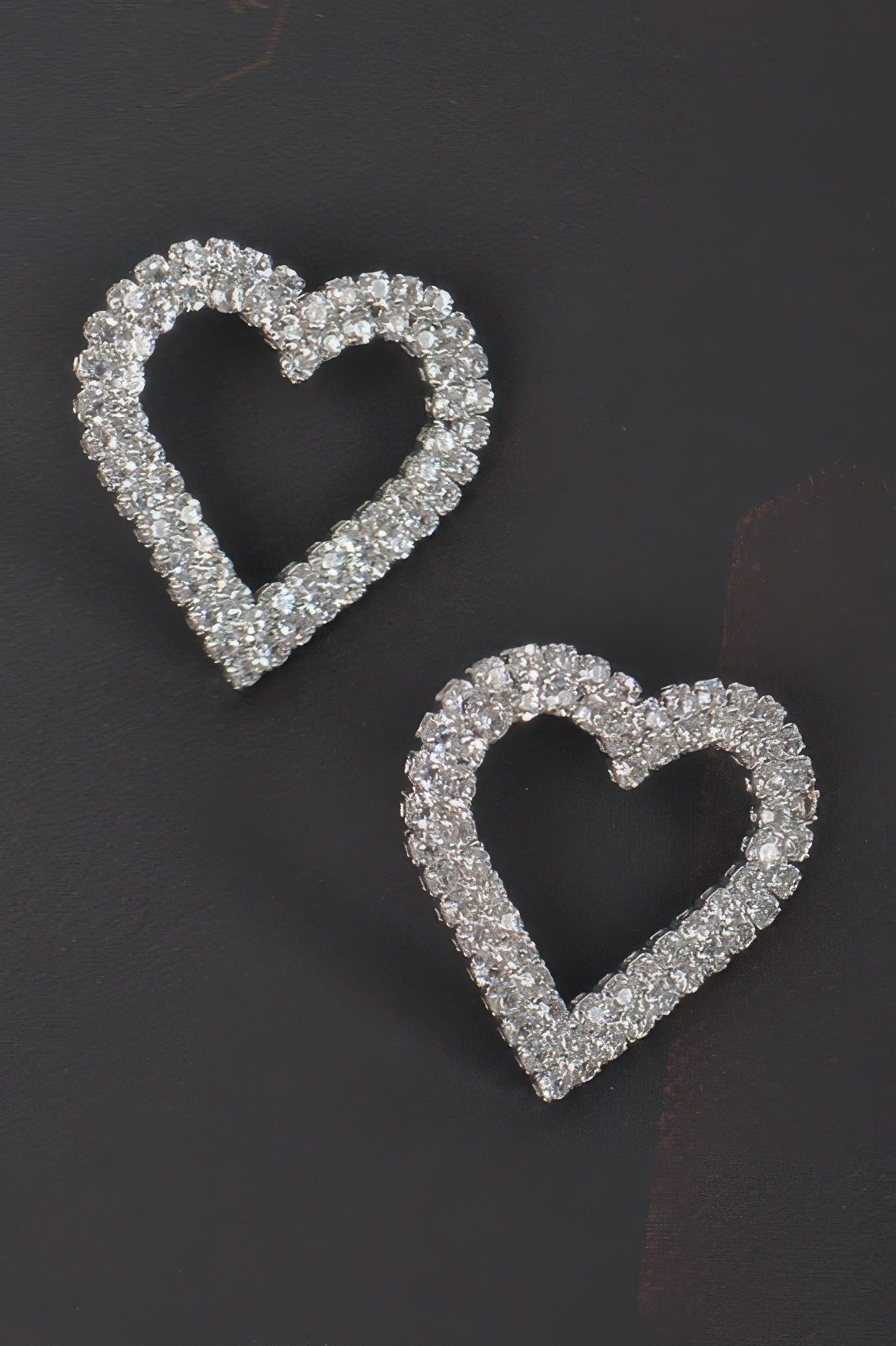 Silver-tone heart rhinestone button earrings with curved heart shape