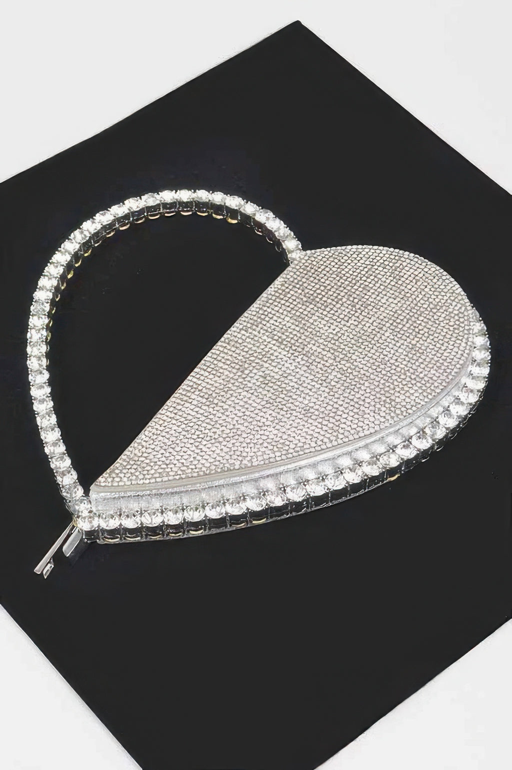 Silver heart rhinestone clutch bag with dangling rhinestone trim and zip closure