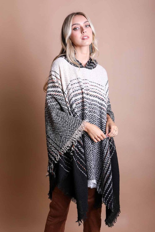 Cream and black herringbone tweed hooded poncho with striped pattern and fringe