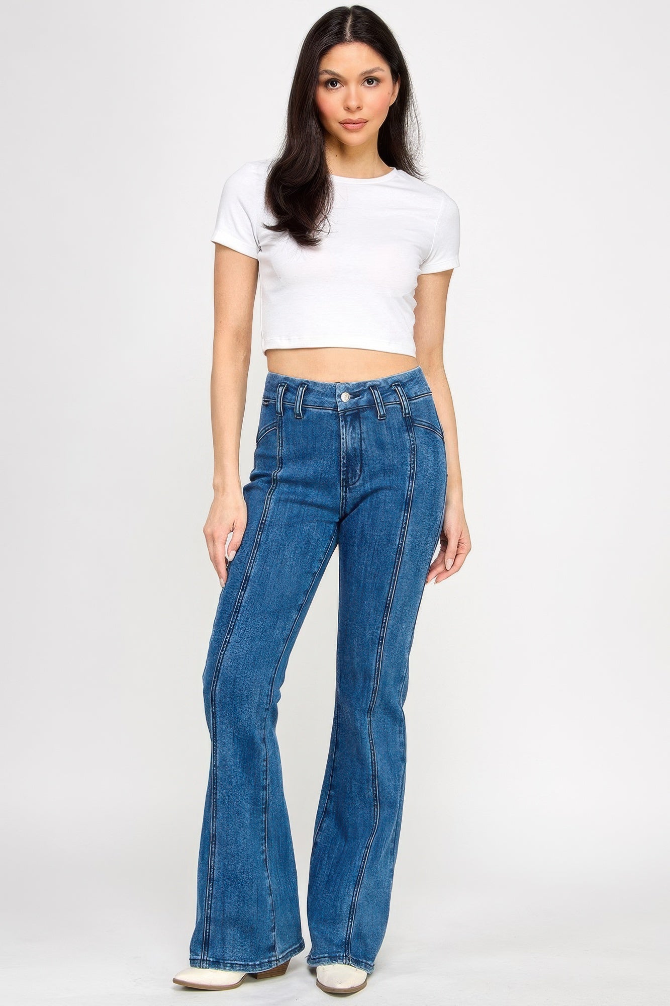 Blue high-rise bell-bottom jeans with front seams and belt loops