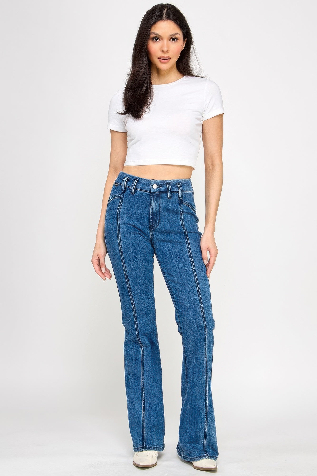 Blue high-rise bell-bottom jeans with front stitch panel and button closure